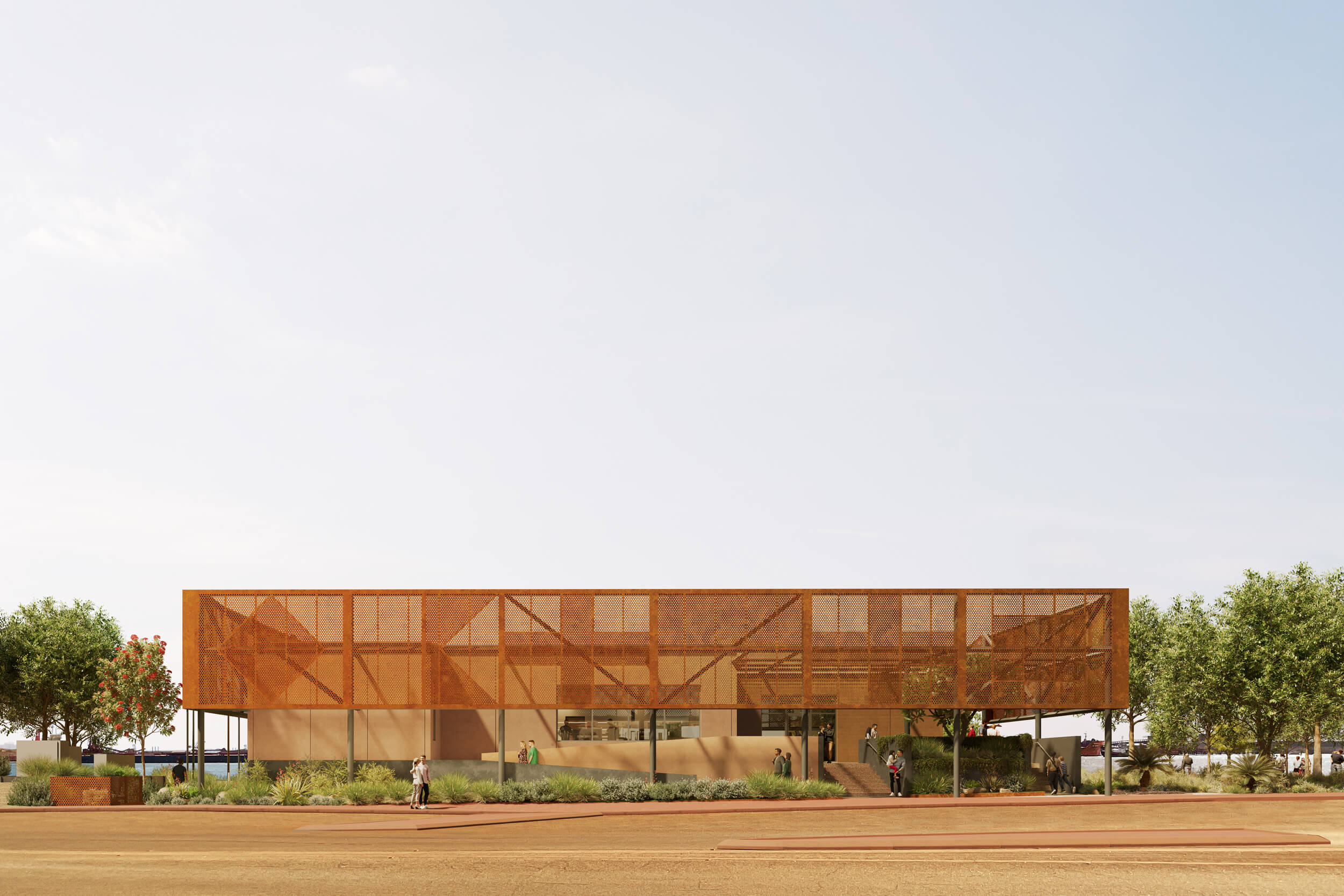 Modern two-story building with perforated rust-colored metal facade, surrounded by greenery and people walking nearby.