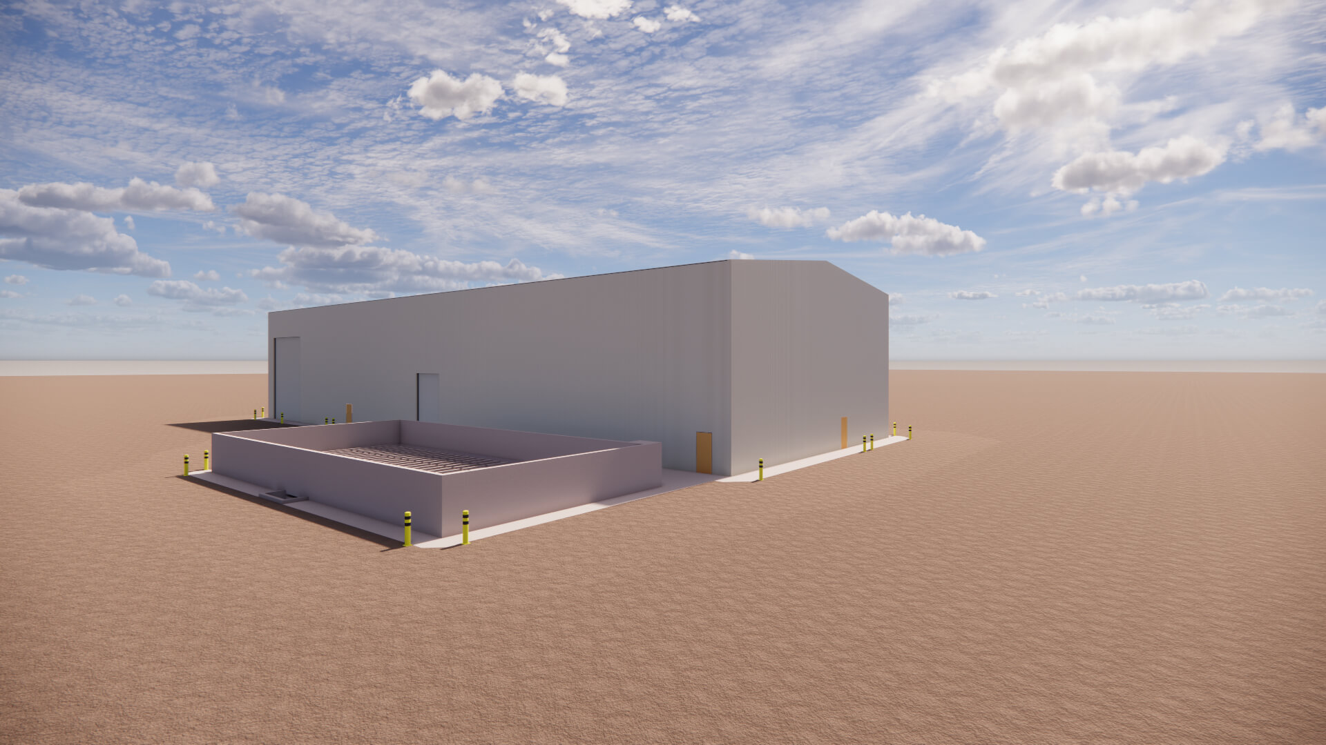 Large gray industrial building with an adjacent low wall enclosure under a partly cloudy sky.